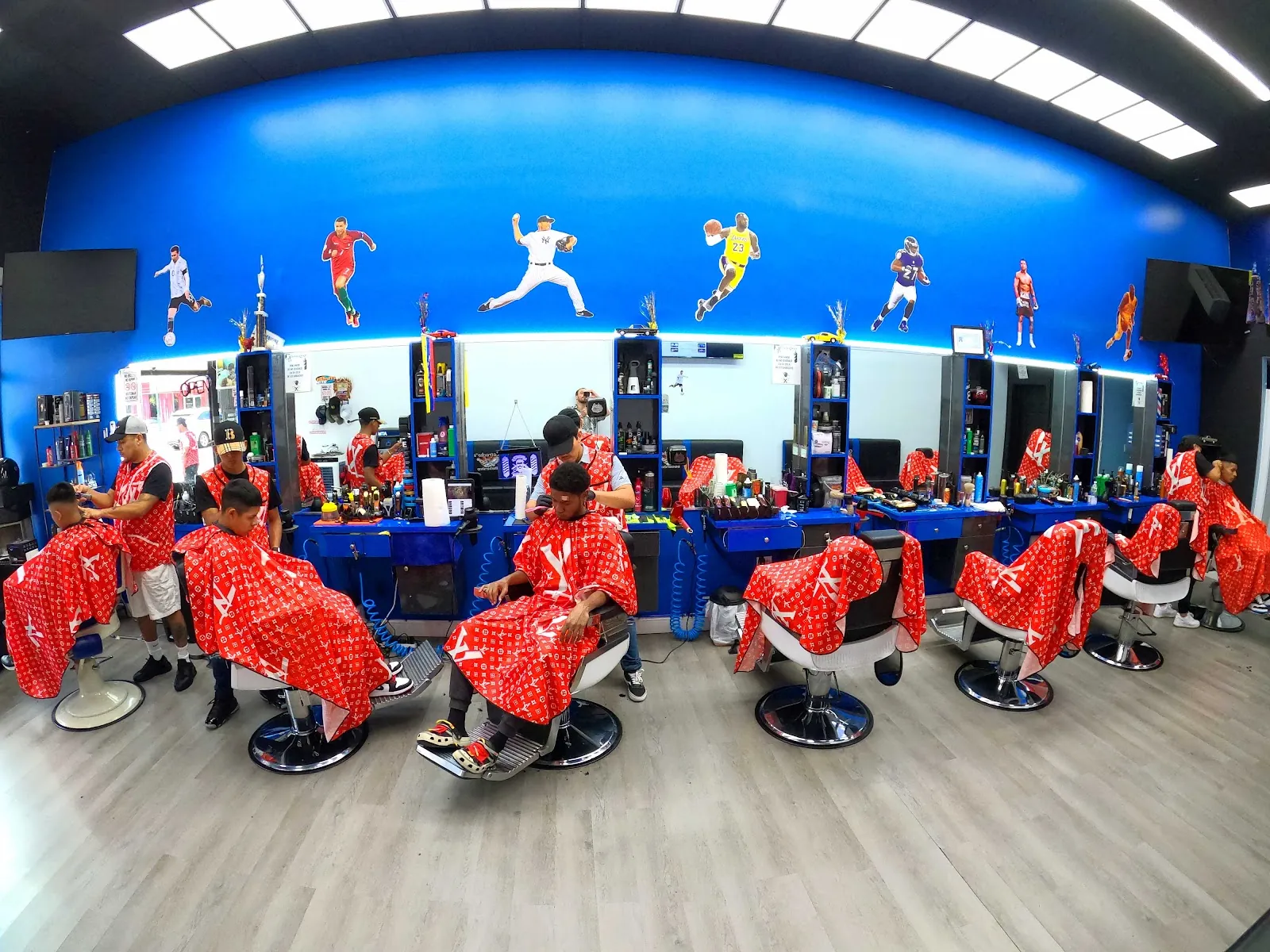 Inside Catracho's: a row of chairs under a blue wall painted with ballplayers and the New York skyline